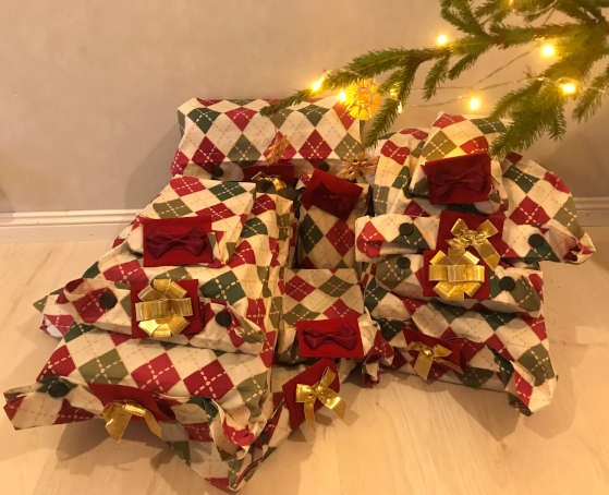 Pile of zaprap gift bags under Christmas tree